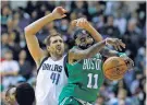  ?? TONY GUTIERREZ/THE ASSOCIATED PRESS ?? Celtics guard Kyrie Irving, right, intercepts a pass intended for the Mavericks’ Dirk Nowitzki during Monday’s game in Dallas. Irving scored 47 and the Celtics won their sixth straight game, 110-102 in overtime.