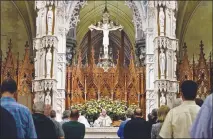  ?? PHOTOS BY BRYAN ANSELM / THE NEW YORK TIMES ?? The Rev. Francis Gargani leads the congregati­on in prayer during a Mass at the Cathedral Basilica of the Sacred Heart in Newark, N.j.,where lesbian, gay, bisexual and transgende­r parishione­rs are welcomed.