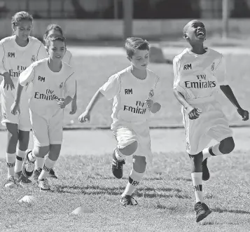  ?? DESMOND BOYLAN, AP ?? Children take part in a clinic organized by the Real Madrid soccer club’s foundation last November in Havana. “You always hear that baseball is Cuba’s game,” author Milton Jamail says. “But it is clearly not the only sport that has captured the...