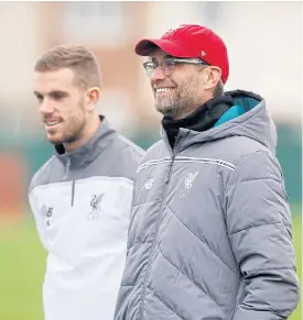  ??  ?? Juergen Klopp, right, and Jordan Henderson during training.