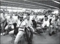  ?? AP/ JUAN CARLOS HERNANDEZ ?? Workers attend a meeting Thursday with government officials at the General Motors plant in Valencia, Venezuela. GM is shuttering operations in the country after authoritie­s seized the factory Wednesday.