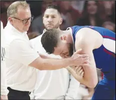  ?? Associated Press ?? Kansas’ Hunter Dickinson (right) is helped after injuring his shoulder during the second half against Houston on March 9 in Houston. Dickinson said his shoulder feels good going into the NCAA Tournament.