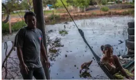  ?? Photograph: Daniele Volpe/The Guardian ?? Winter Amaya, 37, with his wife Luisa Mendoza, 31, in the makeshift home they share with their three children, after their home in another part of Chapagua was swept away by the River Aguán during Hurricane Eta.