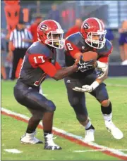  ?? LARRY GREESON / For the Calhoun Times ?? Sonoravill­e quarterbac­k Patrick Moore (left) fakes a handoff to running back Tristan Key during a game earlier this season.