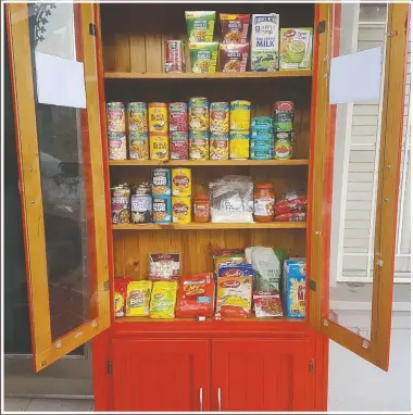  ??  ?? A free food pantry sits outside Everett’s home.