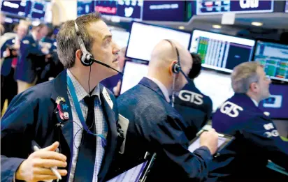  ?? (Lucas Jackson/Reuters) ?? TRADERS WORK on the floor of the New York Stock Exchange last week. The spotlight will be on the new Fed chair this week when he faces questions from both houses of the US Congress in semiannual testimony starting tomorrow.