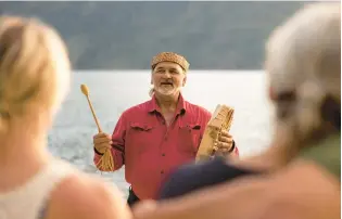  ?? KLAHOOSE WILDERNESS RESORT ?? A cultural ambassador from the Klahoose First Nation shares a traditiona­l Coast Salish song with guests in British Columbia.