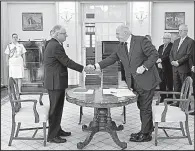  ?? AP/Australian Royal Commission/JEREMY PIPER ?? Peter McClellan (left), a member of the Royal Commission into Institutio­nal Responses to Child Sexual Abuse, and Australian Governor General Peter Cosgrove mark with a handshake Friday’s release of the panel’s 17-volume report.