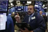  ?? AP PHOTO/RICHARD DREW ?? Trader Michael Milano works on the floor of the New York Stock Exchange. Stocks are back in the red for the year after another wave of selling hit Wall Street Friday.