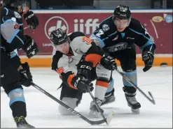  ?? NEWS PHOTO RYAN MCCRACKEN ?? Medicine Hat Tigers centre Jaeger White chips the puck out of his own zone while Kootenay Ice centre Cole Muir pressures during a Feb. 20, 2018 Western Hockey League game at Canalta Centre. White was traded to the Ice Tuesday.