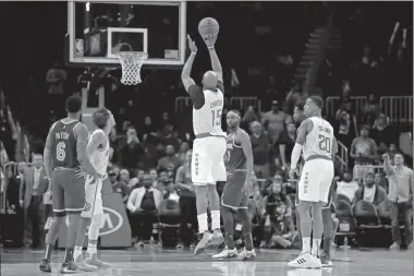  ?? AP-John Bazemore, File ?? Atlanta Hawks guard Vince Carter (15) hits a 3-point basket in the final seconds against the New York Knicks on March 11.