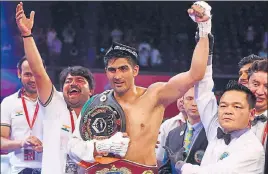  ??  ?? Vijender Singh celebrates his win over China’s Zulpilkar Maimaitial­i in Mumbai on Saturday. PTI