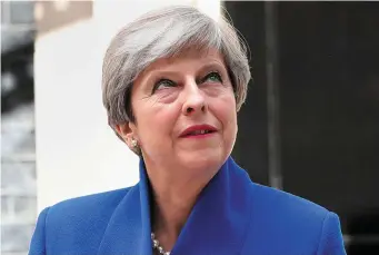  ??  ?? British Prime Minister Theresa May makes a statement outside Downing Street yesterday