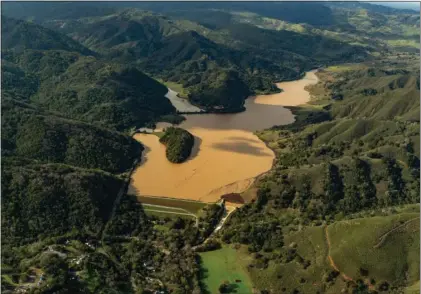  ?? SANTA CLARA VALLEY WATER DISTRICT ?? Uvas Reservoir near Morgan Hill, which was just 18% full in August 2021, expanded to 100% full by January this year following a series of powerful atmospheri­c river storms.