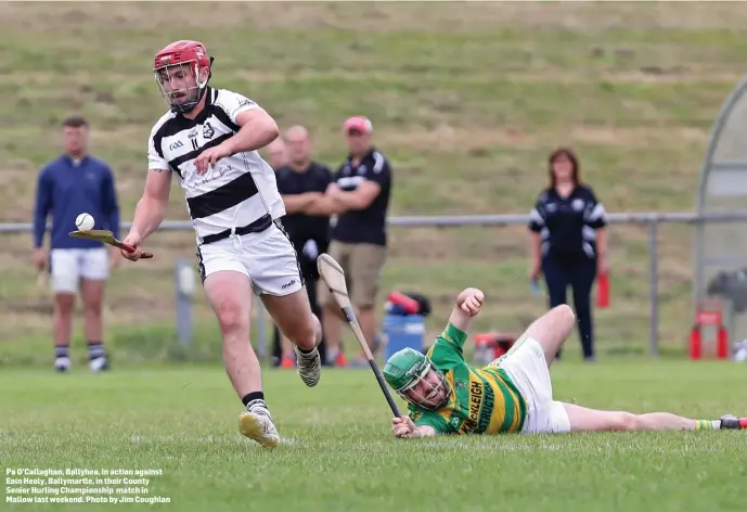  ??  ?? Pa O’Callaghan, Ballyhea, in action against Eoin Healy, Ballymartl­e, in their County Senior Hurling Championsh­ip match in Mallow last weekend. Photo by Jim Coughlan