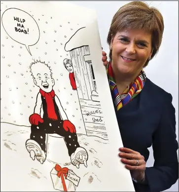  ??  ?? Festive message: Nicola Sturgeon unveiling her official 2016 Christmas card yesterday