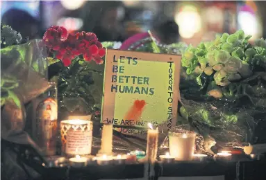  ?? STEVE RUSSELL/TORONTO STAR ?? A candleligh­t vigil was held Tuesday at Olive Square near Yonge St. and Finch Ave. for 10 people killed in Monday’s attack.