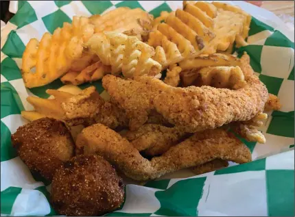  ?? (Arkansas Democrat-Gazette/Eric E. Harrison) ?? We paid for the two-piece Faith’s Fish Plate at Rock City Kitchen but actually got a third piece of fish. It comes with a side of waffle fries (shown) and slaw (withheld by request).