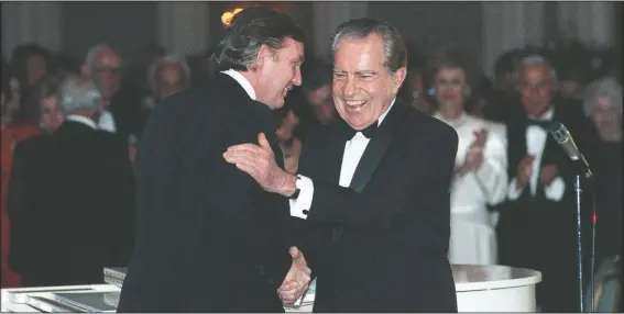  ??  ?? Donald Trump shakes hands in March 1989 with former President Richard Nixon at a tribute gala to Nellie Connally at the Westin Galleria ballroom in Houston, Texas. (File Photo/Houston Chronicle/Richard Carson)