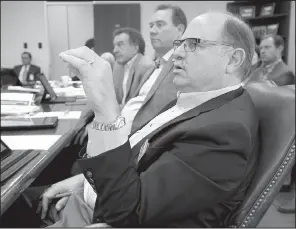  ?? Arkansas Democrat-Gazette/STATON BREIDENTHA­L ?? Arkansas Highway Commission member Philip Taldo (front) asks a question Wednesday along with fellow Commission­ers Alec Farmer (center) and Robert Moore Jr. during a meeting in Little Rock. All voted to seek a ballot initiative in 2018 to raise up to...