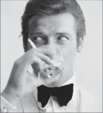  ??  ?? English actor Roger Moore, downs a Martini in 1968. Moore had recently been awarded his second Bravo Otto award for most popular television actor, by German magazine Bravo, for his mystery spy thriller television series, ’The Saint’.
