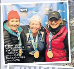 ?? ?? Supportval­erie Storrie celebrates after receiving her medal alongside cousin Andrea Macbeath and pal Jenny Sorbie