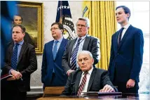  ?? DOUG MILLS / NEW YORK TIMES 2018 ?? John Kelly (seated), then White House chief of staff, told colleagues that the decision to give Jared Kushner (right) top-secret clearance was not supported by career intelligen­ce officials, according to two people familiar with Kelly’s memo.