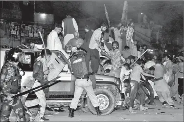  ?? AP/K.M. CHAUDARY ?? Police use force to disperse supporters of former prime minister Nawaz Sharif who gathered to see him in Lahore, Pakistan, Friday. Sharif returned late Friday from London along with his daughter, Maryam, to face a 10-year prison sentence on corruption...