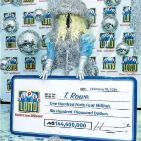  ?? CONTRIBUTE­D ?? Super Lotto winner T. Rowe decked out in a Beyonce Renaissanc­e-era inspired costume was in a celebrator­y mood at the official handover event for the her $144.6 million winnings.