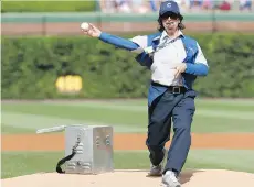  ?? NAM Y. HUH, THE ASSOCIATED PRESS FILES ?? Stephen Colbert, playing the role of Wrigley Field vendor Donny Franks, throws out a first pitch before a game between the Milwaukee Brewers and the Chicago Cubs last month.