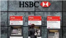  ?? — Reuters ?? A woman uses HSBC machine in central London.