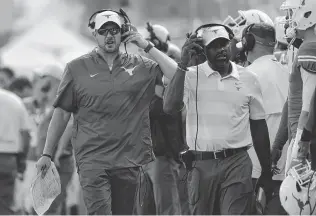  ?? Eric Gay / Associated Press ?? Texas head coach Tom Herman, left, said he believes the offense would require only minor tweaks if starting QB Sam Ehlinger has to sit out. “I think our offense, it’s very easy to plug and play,” he said.