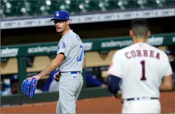  ?? AP Photo/David J Phillip ?? Los Angeles Dodgers relief pitcher Joe Kelly (17) looks back at Houston Astros’ Carlos Correa (1) after the sixth inning of a baseball game on July 28 in Houston. Both benches emptied during the exchange.