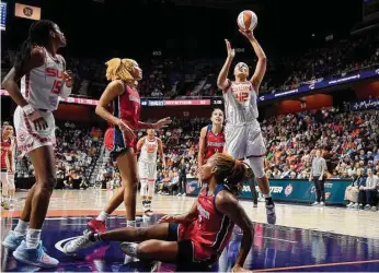  ?? Sarah Gordon/Associated Press ?? The Connecticu­t Sun’s Brionna Jones (42) attempts a basket during a game against the Washington Mystics in Uncasville on Sunday. The Sun’s 80-74 win kicked off a new chapter for the franchise.