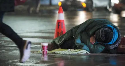  ?? CP FILE PHOTO ?? A homeless person is seen in downtown Toronto on Jan. 3, 2018. Newly released government figures suggest a rising number of newcomers to Canada are ending up in shelters or are finding themselves homeless.