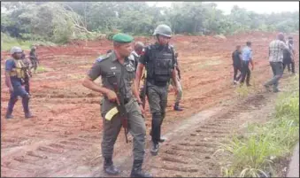  ??  ?? Security operatives mounting patrol by the cleared roadside bush along Benin- Ore Highway