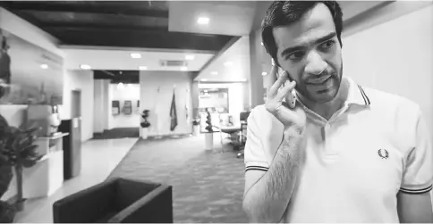  ??  ?? Above picture taken on Aug 17shows Saudi programmer Tawfiq, developer of the ‘Sarahah’ app, talking on his cell phone at his office in the capital Riyadh. Initially conceived as a tool for soliciting bluntly frank workplace feedback, the app ‘Sarahah’...
