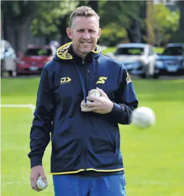  ?? PHOTO GREGOR RICHARDSON ?? Gathering seam . . . Otago Sparks coach Craig Cumming retrieves some balls during a training session at Logan Park earlier this week.