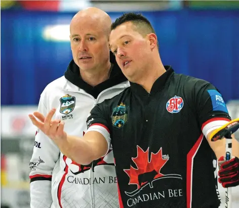  ?? LARRY WONG ?? Skip Kevin Koe, left, discusses a shot with lead Ben Hebert during game action against Team James Paul at the Alberta provincial men’s curling championsh­ip held at the Ellerslie Curling Club in Edmonton on Thursday.