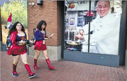 ?? RICHARD VOGEL/THE ASSOCIATED PRESS ?? Women dressed as Supergirl walk along a downtown San Diego street during 2018 Comic-Con.