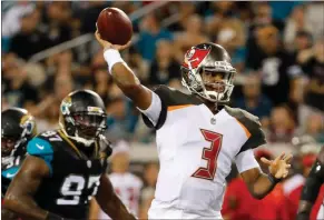  ?? Stephen B. Morton / The Associated Press ?? Tampa Bay’s Jameis Winston (3) throws under pressure from Jacksonvil­le’s Malik Jackson (97) during the first half of Thursday’s preseason game in Jacksonvil­le, Fla.