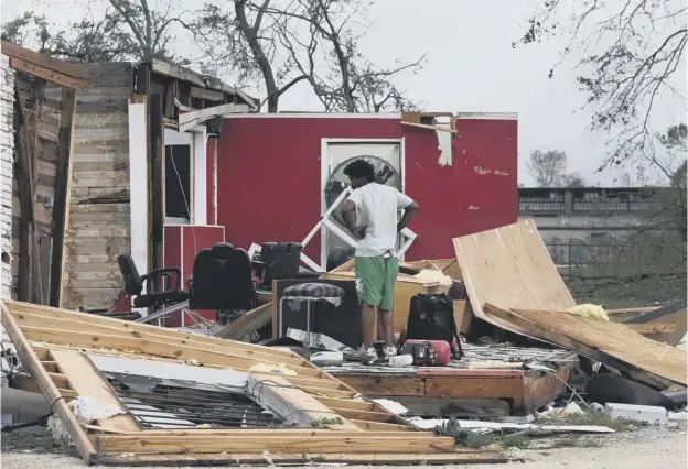  ?? PICTURE: JOE RAEDLE/GETTY IMAGES ?? 0 James Sonya surveys what is left of his uncle’s barber shop after Hurricane Laura passed through Lake Charles, Louisiana