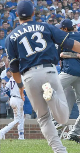  ?? AP ?? The Brewers celebrate after winning the NL Central title Monday at Wrigley Field.