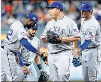  ?? AP PHOTO ?? Texas Rangers pitcher Bartolo Colon is congratula­ted by teammates as he leaves the mound during the eighth inning of a game against the Houston Astros in Houston on April 15.