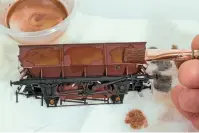  ??  ?? Once the desired level of grime has accumulate­d on the model, rust blooms on the paint surface may be added with washes of Tamiya flat brown, that has been treated with a little matt yellow paint to lighten it. The same colours are used to rust in the underframe­s.
