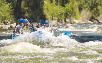  ?? RJ Sangosti, Denver Post file ?? Rafters float the scenic Arkansas River near Buena Vista on May 25. A warm spring saw water levels peak in May, which means many rafting outfitters are now grounded because of summer drought in the parched Rockies.