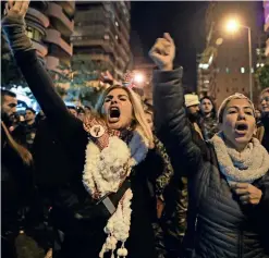  ?? AFP ?? WE DON’T WANT NEW PM: Lebanese protesters shout slogans as they gather outside the Lebanon’s new prime minister’s house in Beirut. —