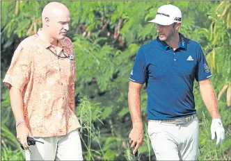  ??  ?? PGA Tour Rules Official Ken Tackett speaks to Dustin Johnson after he played the wrong ball on the fourth hole