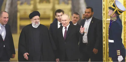  ?? (Sputnik/Sergei Bobylev/Pool via REUTERS) ?? RUSSIAN PRESIDENT Vladimir Putin and Iranian President Ebrahim Raisi enter a hall for Russian-Iranian talks in Moscow, Russia in December.