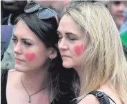  ??  ?? Armed police watch over runners at the Simplyheal­th Great Manchester Run. Right, a spectator sheds a tear during a minute’s silence at the starting line. Below: former senior Metropolit­an police officer, Tarique Ghaffur